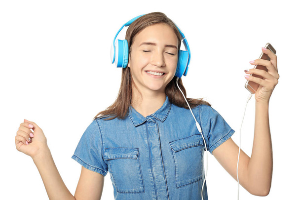Attractive teenage girl listening to music, isolated on white - Фото, зображення