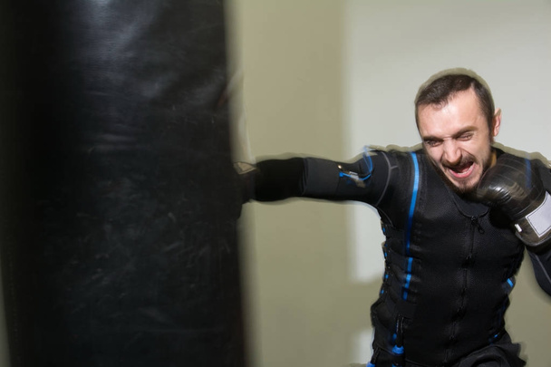 Strong man in boxing gloves during training. - Photo, Image
