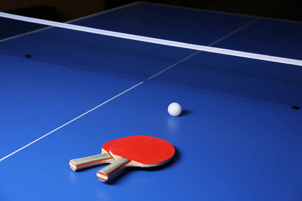 Ping pong rackets and ball on table - Fotó, kép