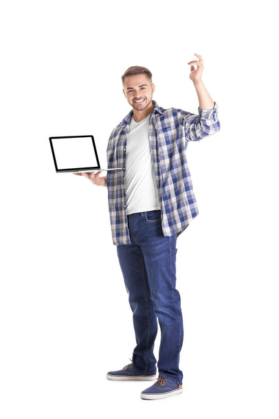 Young man with laptop - Fotó, kép
