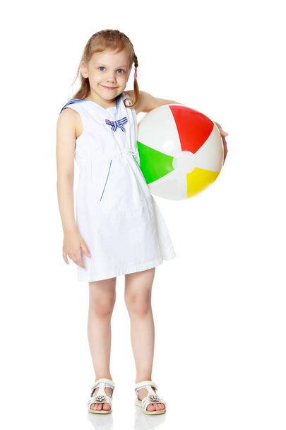 Little girl is playing with a ball - Φωτογραφία, εικόνα