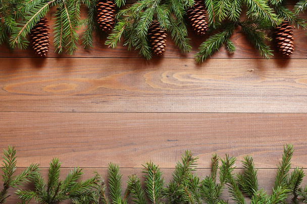 Fir-tree branches on a wooden table - Фото, зображення