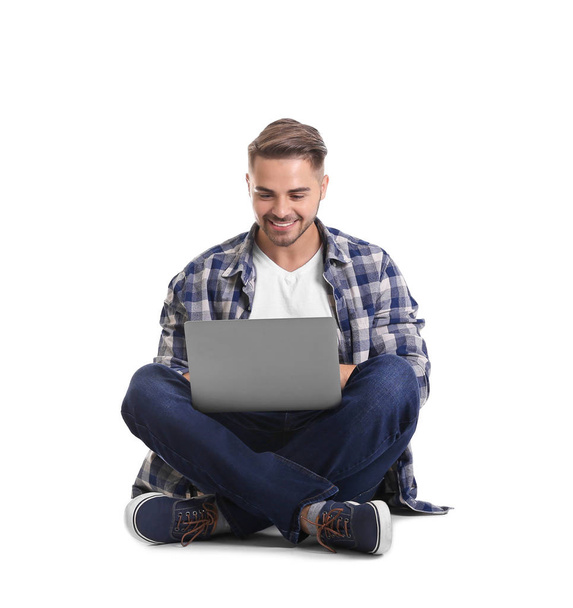 Young man with laptop - Фото, изображение