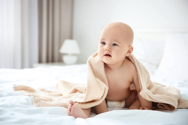 boy with towel on bed - Foto, Imagen