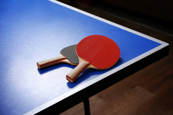 Two ping pong rackets on table - Фото, изображение