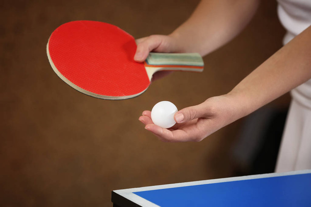 Woman playing table tennis indoors - 写真・画像