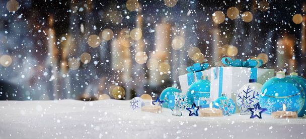 Blue and white christmas gifts and baubles on snow 3D rendering - Photo, image