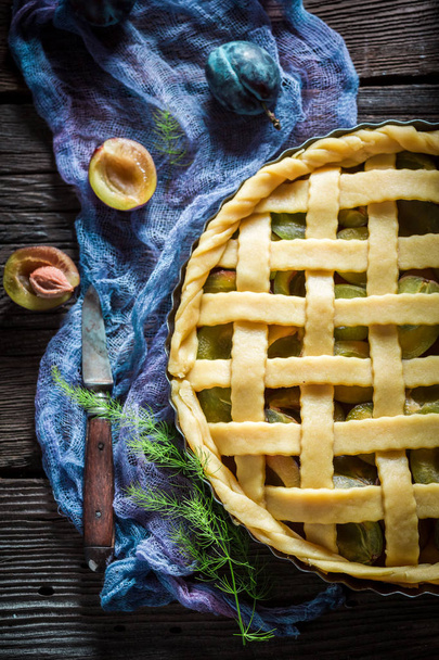 Sweet and tasty plum pie on blue cloth - Foto, imagen