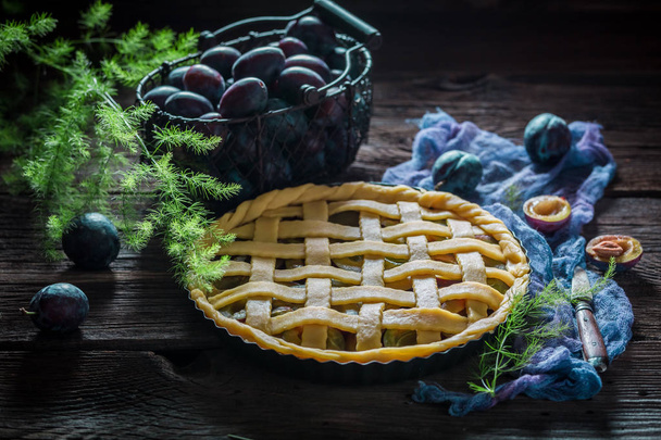 Sweet and tasty tart with plums on blue cloth - Фото, зображення