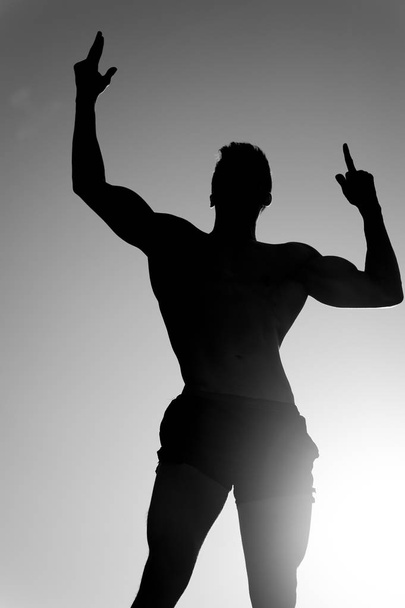 Silhouette of strong man - 写真・画像