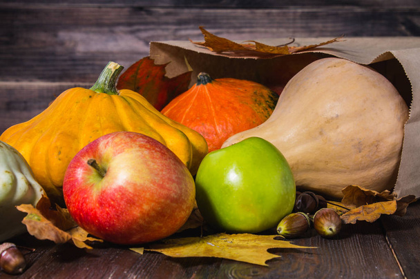 Autumn nature concept. Fall pumpkins and apples on wooden rustic table. Thanksgiving dinner. - Valokuva, kuva