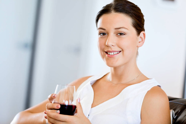 Beautiful young woman holding glass with red wine - Fotografie, Obrázek