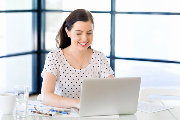 Портрет деловой женщины, работающей за компьютером в офисе
 - Фото, изображение