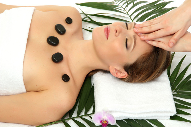 Portrait of beautiful woman with spa stones taking head massage - Фото, изображение