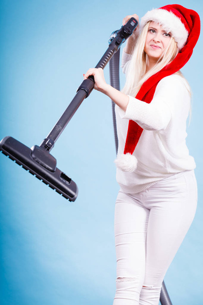 Girl in santa helper hat with vacuum cleaner - Foto, immagini