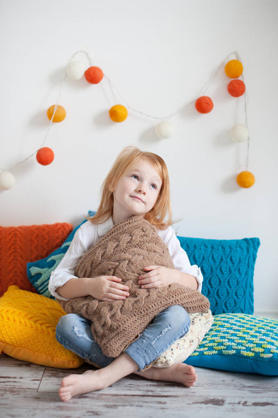 Girl sitting on pillows - Photo, image