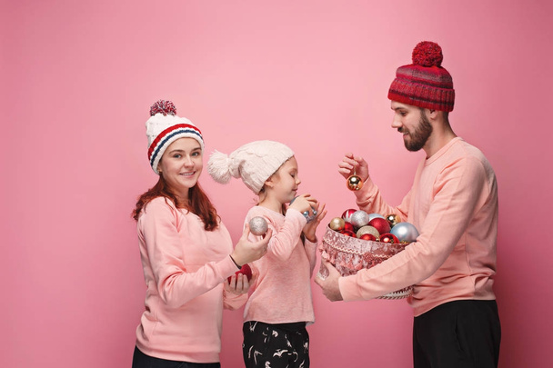 Father and mother give gifts to little daughter at studio - 写真・画像