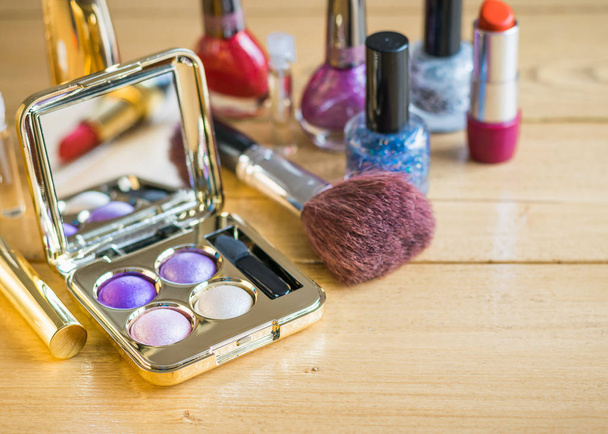 Set of women's cosmetics with mirror on the wooden table. - Photo, Image