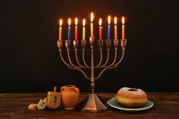 image of spinnig top, menorah (traditional candelabra) and burning candles - Foto, Imagen