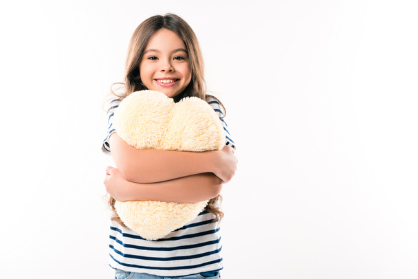 child hugging heart shaped pillow - Fotó, kép