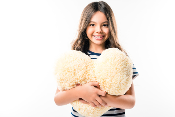 child holding heart shaped pillow - Foto, afbeelding
