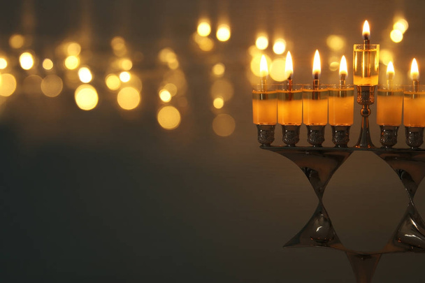 image of jewish holiday Hanukkah background with menorah (traditional candelabra) and burning candles. - Foto, afbeelding