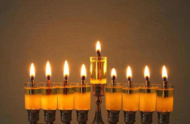 image of jewish holiday Hanukkah background with menorah (traditional candelabra) and burning candles. - Фото, изображение
