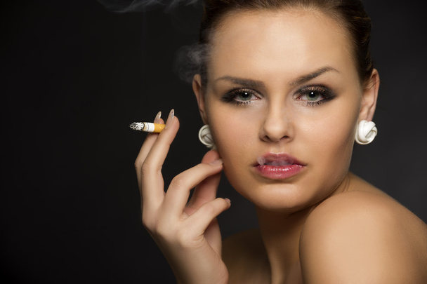 Stylish woman smoking a cigarette - Photo, Image