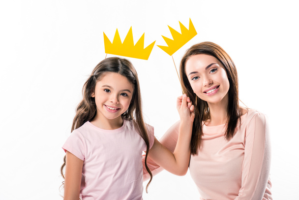 Mother and daughter with paper crowns on stick - Photo, Image