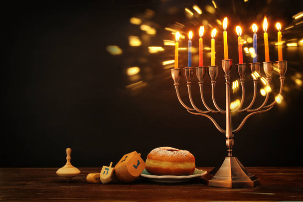 image of jewish holiday Hanukkah background with traditional spinnig top, menorah (traditional candelabra) - Foto, afbeelding