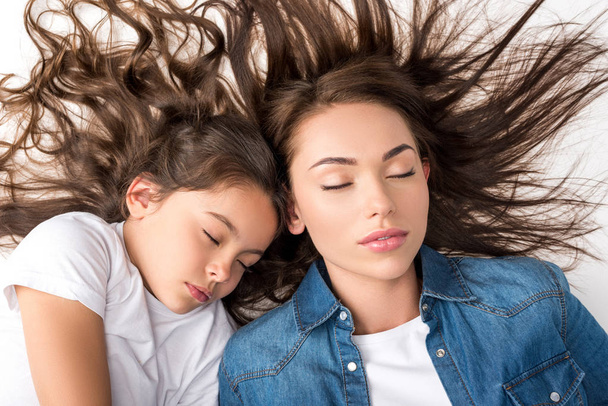 mother and daughter sleeping together - Photo, Image