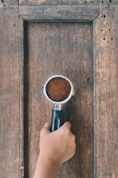 Freshly ground coffee beans in a metal filter  - Zdjęcie, obraz