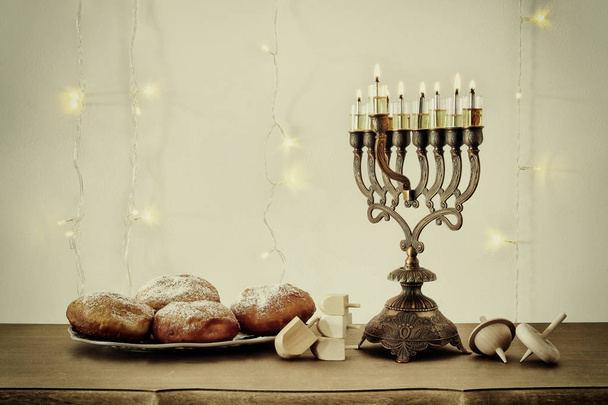 image of jewish holiday Hanukkah background with traditional spinnig top, menorah (traditional candelabra) - Foto, imagen