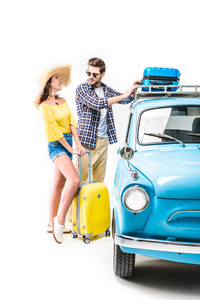 couple putting luggage on car roof - 写真・画像