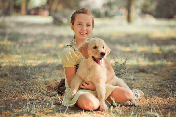 Retriever pup Lovely scene cute young teen girl enjoying posing summer time vacation with best friend dog ivory white labrador puppy.Happy airily careless childhood life world of dreams with puppies - Photo, Image