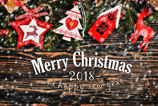 Christmas background with Christmas tree and Christmas tree decorations, and Merry Christmas and Happy New Year 2018 text on wooden background. - Foto, Bild
