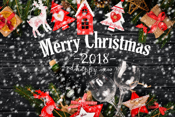 Christmas background with Christmas tree and Christmas tree decorations, and Merry Christmas and Happy New Year 2018 text on wooden background. - Фото, зображення