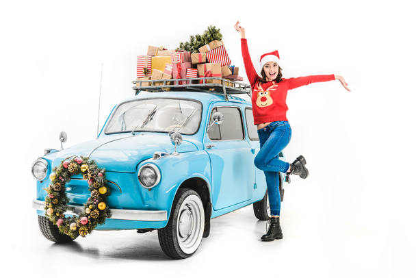 woman with christmas gifts on car roof - Valokuva, kuva