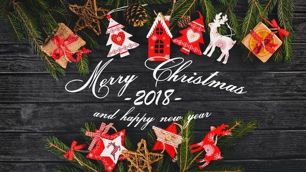 Christmas background with Christmas tree and Christmas tree decorations, and Merry Christmas and Happy New Year 2018 text on wooden background. - Fotoğraf, Görsel