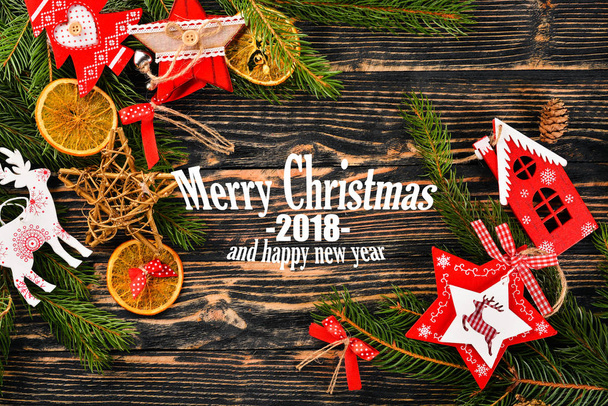Christmas background with Christmas tree and Christmas tree decorations, and Merry Christmas and Happy New Year 2018 text on wooden background. - Fotoğraf, Görsel
