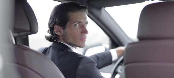 man sitting behind the wheel of a car - Fotografie, Obrázek