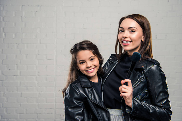 Daughter and mother with makeup brush - Photo, Image