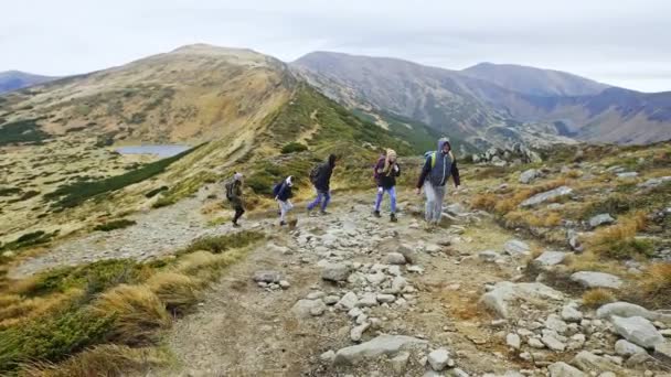 Group of young people hiking in mountains - Felvétel, videó
