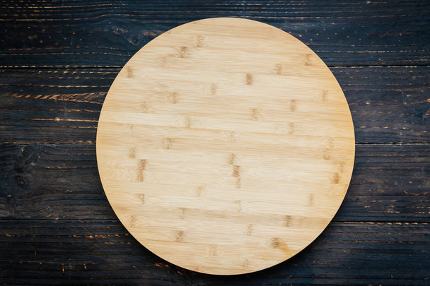 Wood cutting board on wooden background with copy space - Foto, imagen