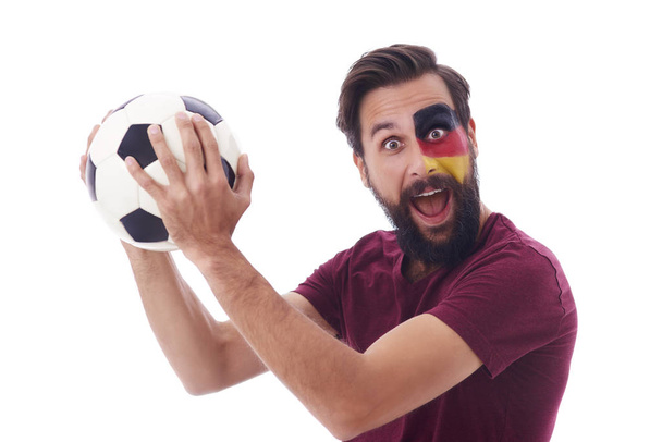 Cheerful soccer fan with soccer ball celebrtaing  - 写真・画像