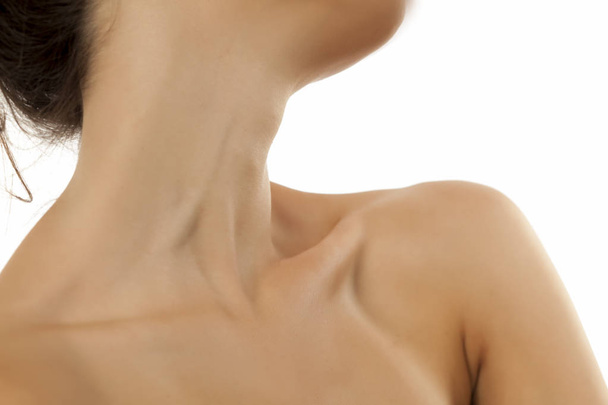 Woman`s neck and bare shoulder on a white background - Photo, Image