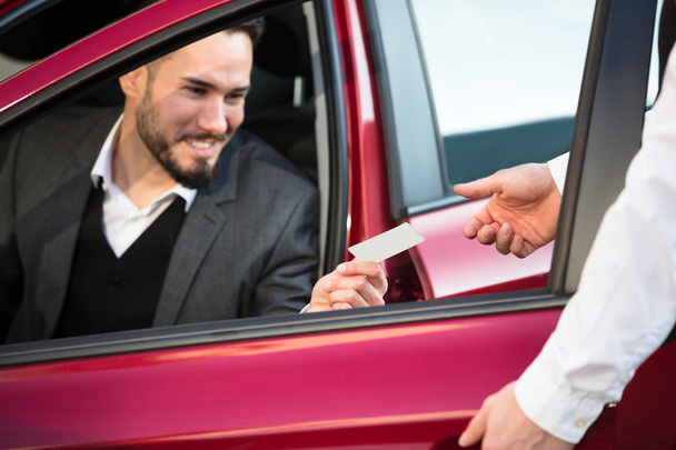 Valet Giving Receipt To Businessperson  - Photo, Image