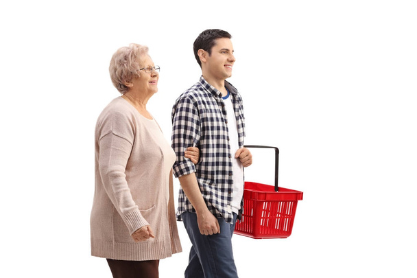 woman with man holding an empty shopping basket  - 写真・画像