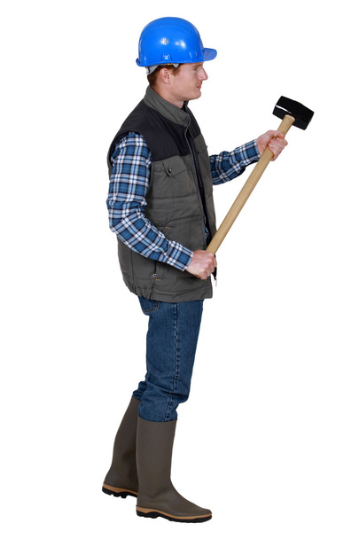 Labourer holding a mallet - Фото, зображення