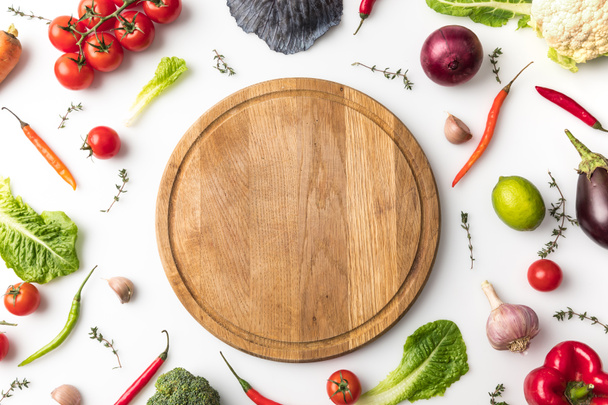 wooden board among vegetables - Photo, Image